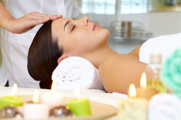 Portrait of young female enjoying the procedure of facial massage